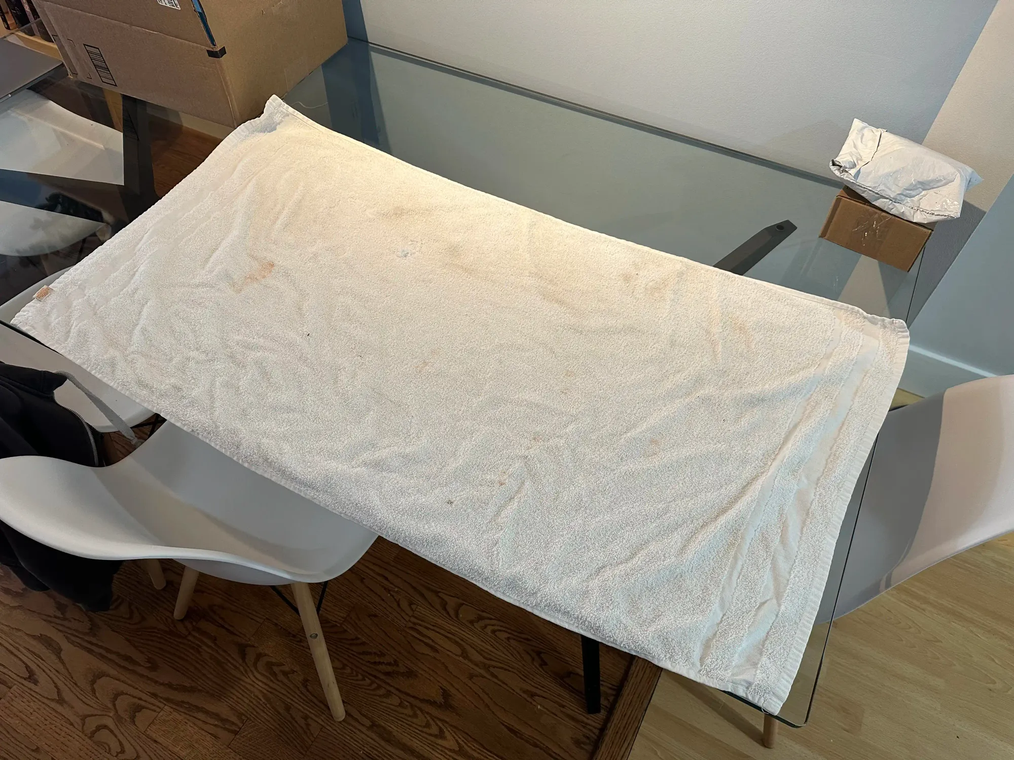 A flat white towel on a table.