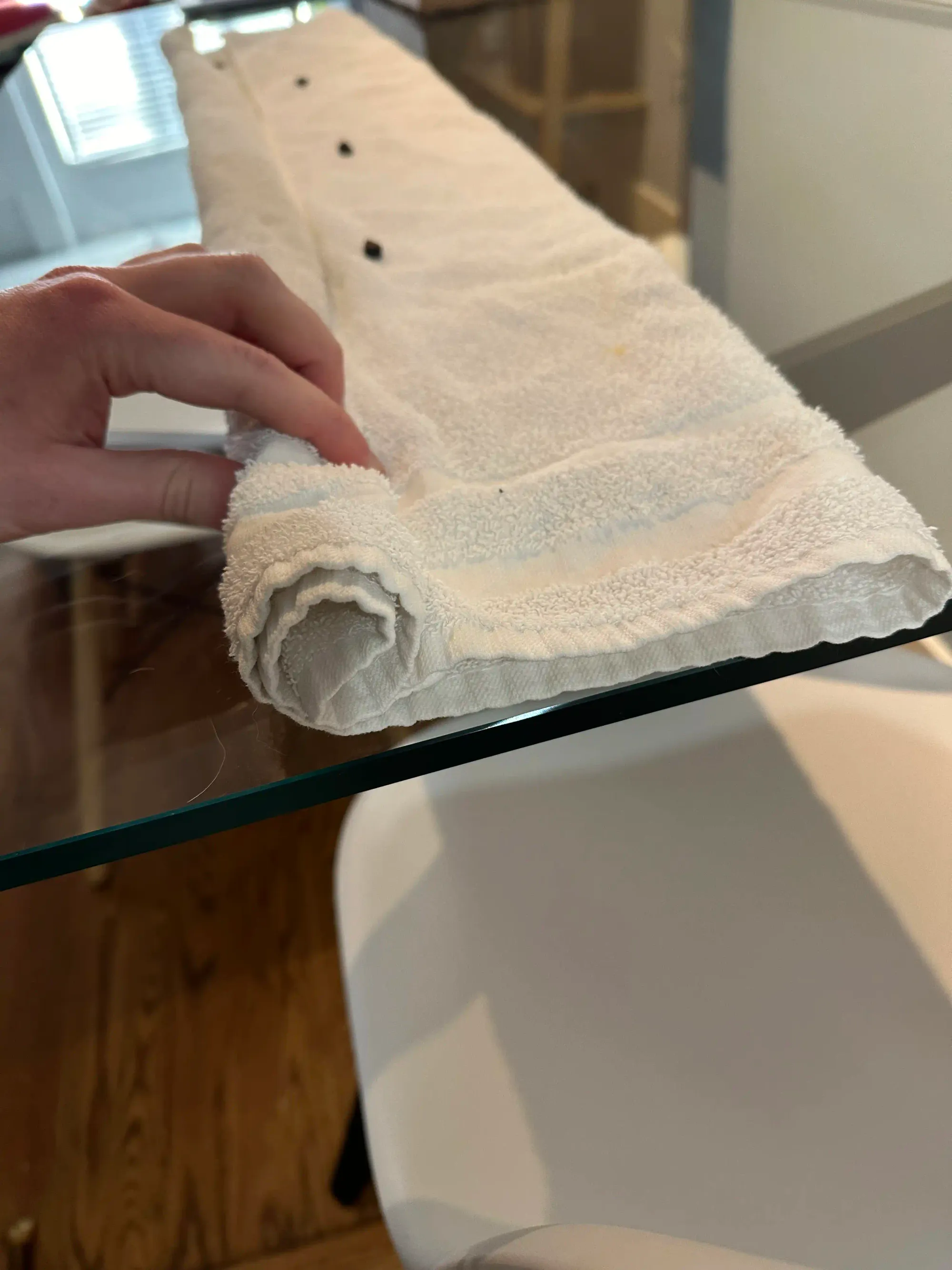 A man rolls a towel. There are dog treats on the inside.